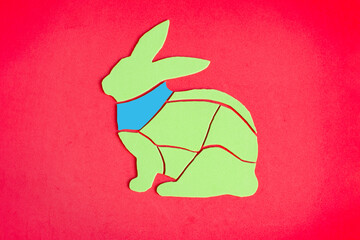 An image of a rabbit carcass with a brightly highlighted neck. The meat fillet of rabbit is schematically shown.