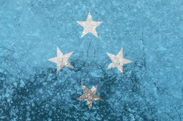 National flag The flag of the Federated States of Micronesia on a background of snow with large snow crystals close-up
