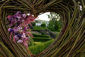 Beautiful view of the staircase in a cozy green garden framed by branches and flowers