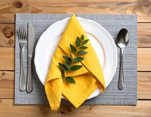 Table setting with yellow napkin and green sprig