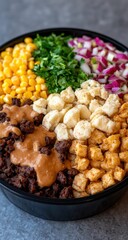 Bowl of colorful ingredients, gravy, meat, cheese, and corn