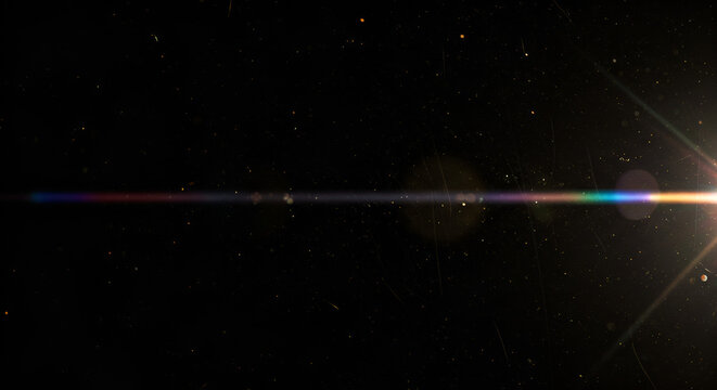 Dramatic lens flare overlay with stars dust and scratches on a dark background