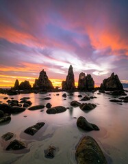 Dramatic Sunset Over Jagged Sea Stacks and Beach