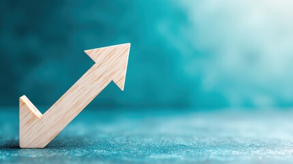 Wooden arrow pointing upwards, symbolizing growth, success, and progress, is displayed against a blurred, textured teal background.