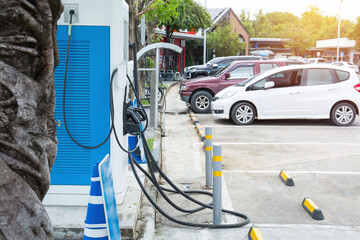 Modern fast electric vehicle chargers for charging car in park.Green power concept.