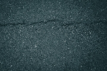 Close-up cracked asphalt road pavement texture background.
