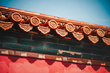 A vibrant section of a building's facade, hinting at The Palace Museum, Beijing.  The detailed roof...