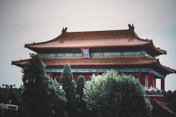 An exterior shot captures The Palace Museum in Beijing. This historic, tiered structure features a...
