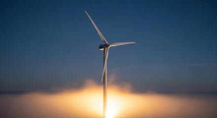 Obraz premium Modern wind turbine generating clean energy at night with a dramatic glowing horizon
