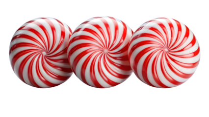 Three peppermint candies with red and white spirals isolated on black background