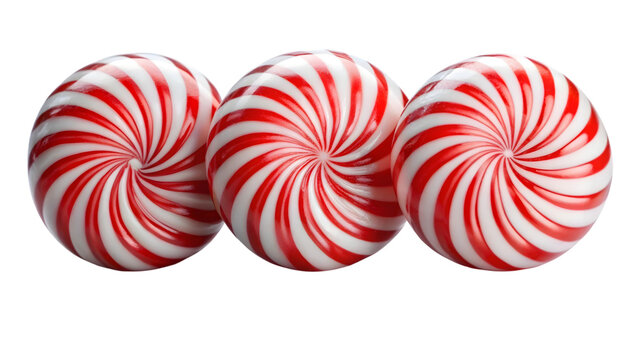 Three peppermint candies with red and white spirals isolated on black background