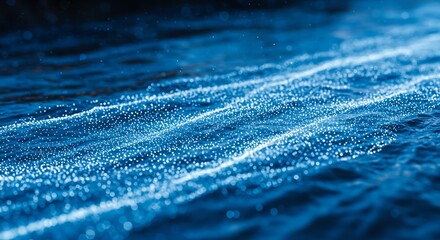 Bioluminescent plankton creating glowing trails on the surface of the ocean at night.