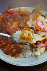 Spiced Chicken and Egg Rice, captured on October 2, 2025. Steamed rice served with flavorful spiced chicken, seasoned boiled egg, aromatic herbs, and colorful side dishes, authentic Indonesian cuisine