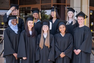 Obraz premium Multinational students in graduation gowns. 