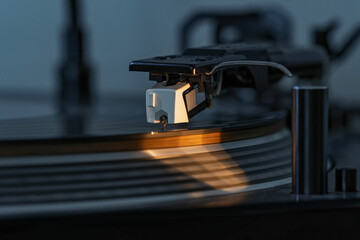 Close-up view of a stylus on a spinning record as it plays music.