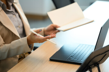Close up of businesswoman working on laptop, concept of technology and productivity