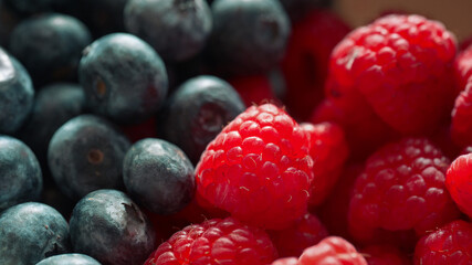 Close up view of fresh blueberries and raspberries showcasing vibrant colors and natural texture