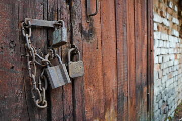 The lock on the old wooden door of the garage and barn.