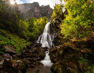 Mountain waterfall cascading through lush greenery