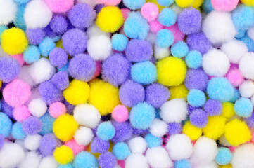 Small pastel coloured crafting pom pom background texture detail