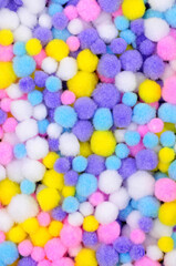 Small pastel coloured crafting pom pom background texture detail