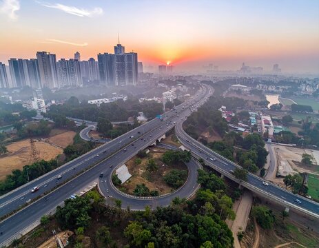Urban sunrise highway and buildings under a hazy sky
