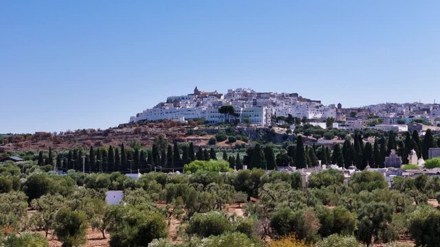Beautiful Ostuni cityscape in horizon, low angle aerial view
