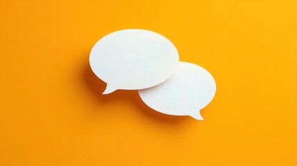 Two white speech bubbles stand out vividly against a bright orange backdrop,