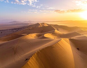 Golden dunes ripple under a vibrant sunrise sky