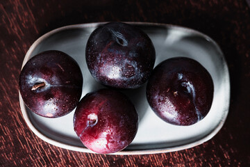 organic fresh ripe plum, seasonal fruit in rustic style
