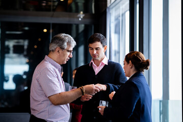 Indian and White Business professionals talking at a rooftop restaurant, highlighting partnership, negotiation, and corporate connection in an elegant environment.