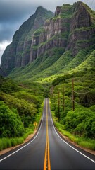 Fototapeta premium Scenic highway leading through lush green mountains under a dramatic cloudy sky