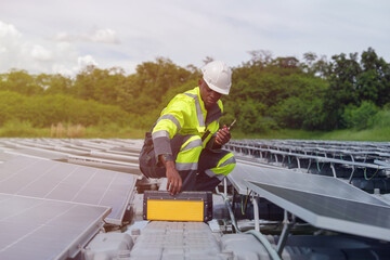Male engineer working on installing floating solar panels. An engineer or worker is working on solar panels or photovoltaic cells on the roof of a business building.