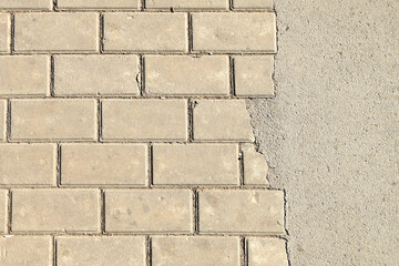 Beige brick wall close-up. Detailed beige brick wall texture with clean rectangular arrangement, neutral architectural background.