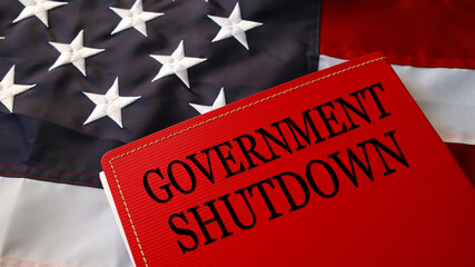 Government Shutdown text on red folder over American flag, symbol of political crisis, budget...