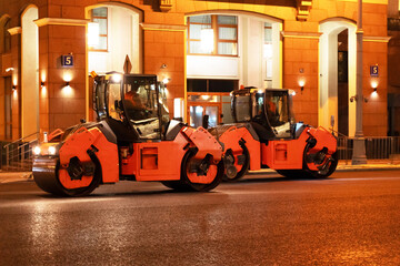 Heavy machinery works on street repair at night in urban area