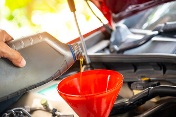 Refueling and pouring oil quality into the engine motor car Transmission and Maintenance Gear...
