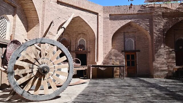 Courtyard in a workshop with a wagon wheel in Khiva, Uzbekistan