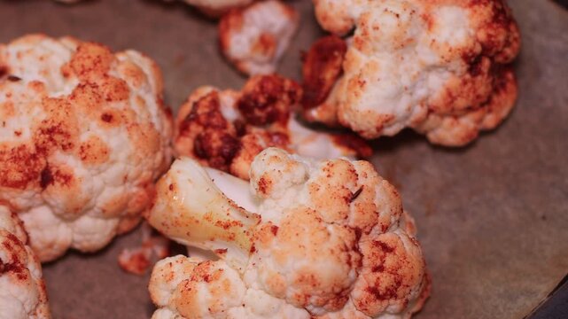Oven-baked cauliflower florets topped with a flavourful sauce made from olive oil, sweet paprika, garlic, and cumin, perfect for a healthy dinner.