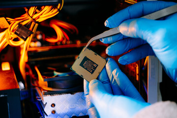 Closeup of technician holding CPU chip inside computer case, symbolizing hardware repair, upgrade, technology innovation, and IT service.