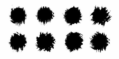 Collection of eight black grunge splatter paint brush stroke textures on white background