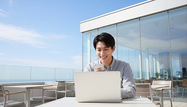 海が見えるテラスでリモートワークする男性 - Powered by Adobe