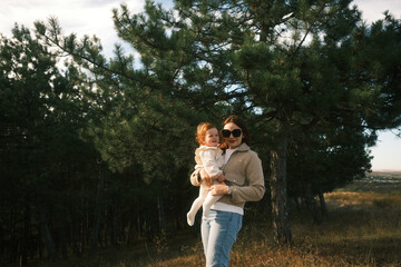 A Mother and Her Child Joyfully Embracing the Wonders of Nature in a Serene Setting