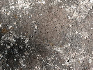 Rough textured concrete surface with cracks and small stones