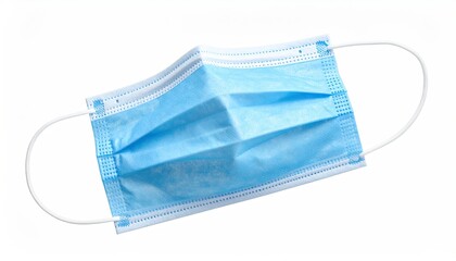 Top-down view of a blue disposable face covering, white background, white elastic