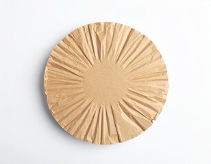 Circular brown paper object, rippled edges, center circle, isolated on white surface