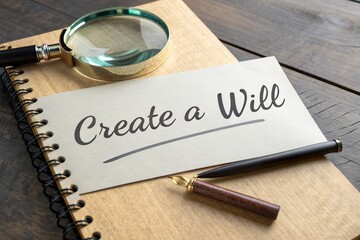 Fototapeta premium Close-up of a wooden table with a notepad, pen, and magnifying glass, emphasizing the importance of creating a will