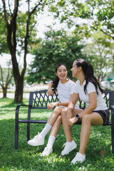 Fototapeta premium Young asian women resting discussing health outdoors