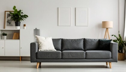 Obraz premium Grey settee near white cupboard in minimal living room interior with posters on the wall