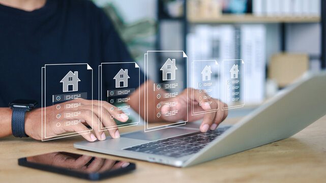Businessman using digital tablet with virtual property documents and checklist icons. Concept of real estate technology, online mortgage, smart contract, and house investment.
